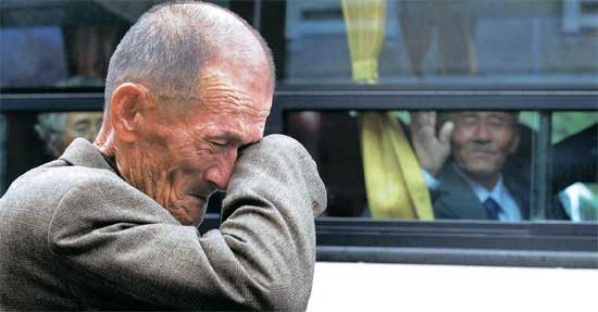 南北離散家族再会行事２日目の３１日、北朝鮮の家族らがバスで会場を離れ、韓国側参加者が涙をぬぐっている。