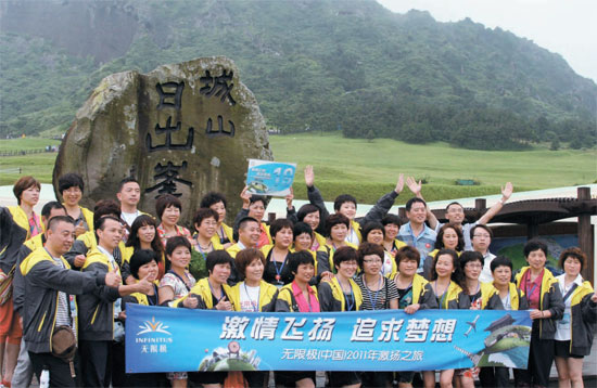 ４日、済州道城山日出峰を訪れた中国人団体観光客が記念撮影をしている。 健康食品会社Ｉｎｆｉｎｉｔｕｓの職員で、２０１３人が済州を訪れた。 （写真＝済州コンベンションビューロー）