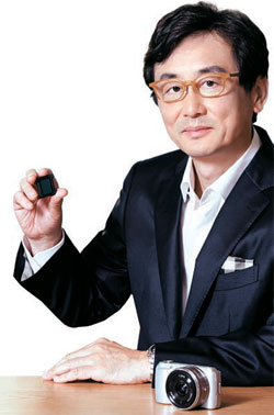 ソニーコリアの糸木公広社長社長がデジタルカメラに入るＣＭＯＳセンサーを見せている。