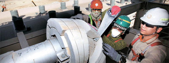 先月５日（現地時間）、サウジアラビア西部ヤンブーの発電・淡水プラント現場で、ハンファ建設の技術者キム・ギュナムさん（右）が外国人職員に装備の使用方法を教えている。