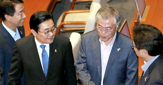 新政治連合の文在寅（ムン・ジェイン）議員が３日、国会本会議場で同党議員らと語っている。