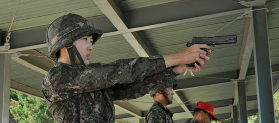 ＳＫグループの崔泰源会長の娘であるミンジョンさんが海軍士官候補生（ＯＣＳ）の訓練中に拳銃射撃をしている。（写真提供＝海軍士官学校）