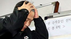 思潮産業の社長が２日、釜山オリョン号事故対策本部で行方不明者の家族に救助状況を説明した後、頭を抱えて席を外している。