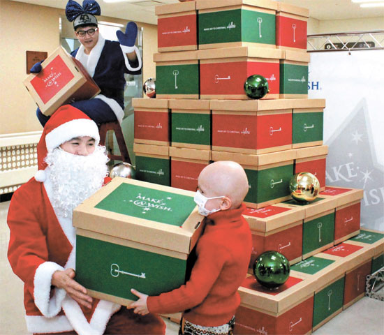 ２２日、ソウル新村洞のセブランス病院を訪問したギャラリアデパートと韓国メーク・ア・ウィッシュ財団のボランティア団員が難病患者のための「分かち合いツリー」を設置してクリスマスプレゼントを贈った。（写真提供＝ギャラリアデパート）