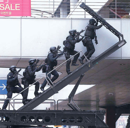 ２９日、ソウル駅広場で開かれた対テロ総合訓練で、警察の特攻隊員がはしごを昇って現場に向かっている。