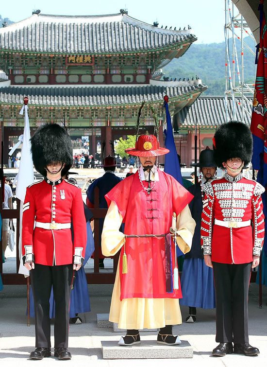 ２８日午前、ソウル景福宮の正門である光化門で英国王室の近衛兵守門将と並んでポーズを取っている。