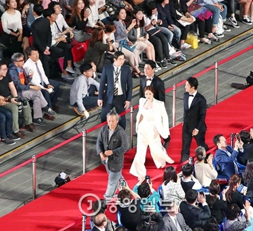 ６日、釜山海雲台区の映画の殿堂野外劇場で第２１回釜山国際映画祭開幕式が開かれた。開幕式に出席した（左から）キム・ギドク監督と出演者のアン・ジヘ、チェ・ギファ、ファン・ゴンがレッドカーペットを踏んでいる。