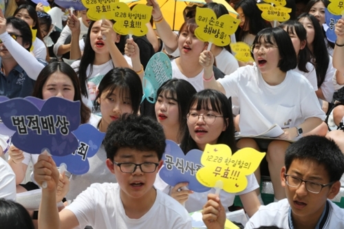 韓国挺身隊問題対策協議が主催した第１２９２回水曜集会がソウル鍾路区駐韓日本大使館前で開かれた。行事に参加した学生たちが掛け声を叫んでいる。