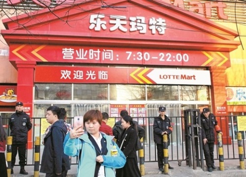 中国・北京のロッテマート前である女性が自撮りをしている。この店舗を含めほとんどのロッテマート店舗が数カ月にわたり営業停止状態だ。（写真＝中央フォト）