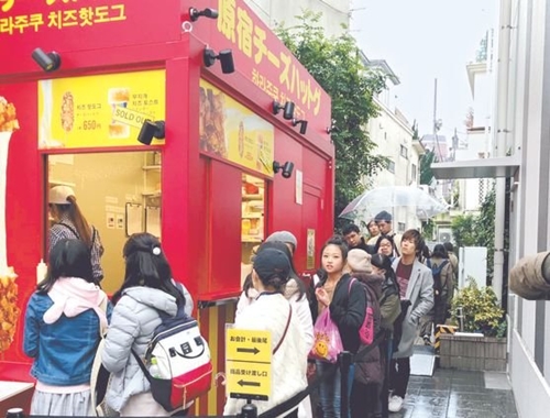 先月２２日、東京原宿の韓国風チーズドッグの屋台の前に長い行列をつくった顧客
