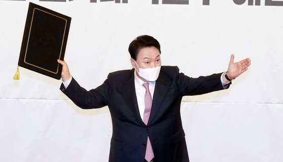 第２０代大統領当選者の尹錫悦氏が１０日、国民の力選対委解団式で当選証を見せている。［写真　国会写真記者団］