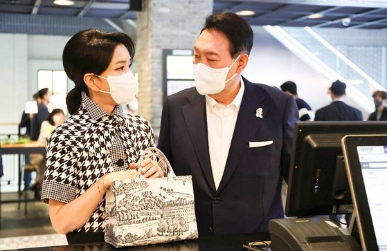 尹錫悦（ユン・ソクヨル）大統領と金建希（キム・ゴンヒ）夫人が１２日、ソウル・メガボックス聖水（ソンス）店で映画『ベイビー・ブローカー』の観覧に先立ち、ポップコーンを購入している。［写真　韓国大統領室］