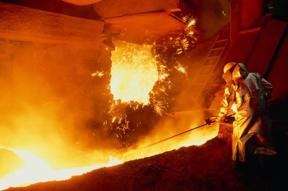 ポスコの職員が溶鉱炉で１５００度を超える鉄が問題なく流れ出るよう出湯口の整理作業をしている。　［写真　ポスコ］