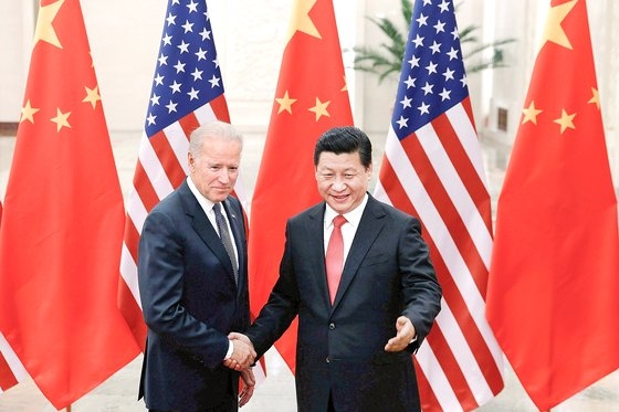 ２０１３年１２月、当時のバイデン米副大統領（左）が中国を訪問し、習近平国家主席（右）と握手している。　［中央フォト］