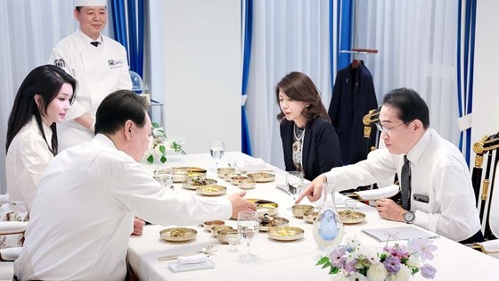 尹大統領と岸田首相が料理を前にして言葉を交わしている様子。［写真　韓国大統領室］