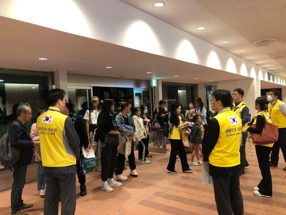 ２１日、在日韓国大使館の関係者らが東京羽田空港で、日本の輸送機に乗ってイスラエルから退避した韓国人を出迎えた。　［写真　外交部］