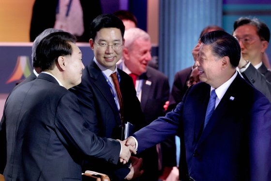 １６日（現地時間）、ＡＰＥＣセッション１会議で習近平国家主席とあいさつを交わす尹錫悦（ン・ソクヨル）大統領（左）　キム・ヒョンドン記者