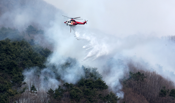 慶南山清郡で始まった山火事４日目の２４日、山清郡矢川面でヘリコプターが鎮火のため水をかけている。　ソン・ボングン記者