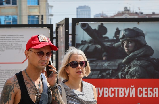 ７日（現地時間）、ロシアのカザンで市民が軍人のポスターの前を歩いている。　［ＥＰＡ＝聯合ニュース］