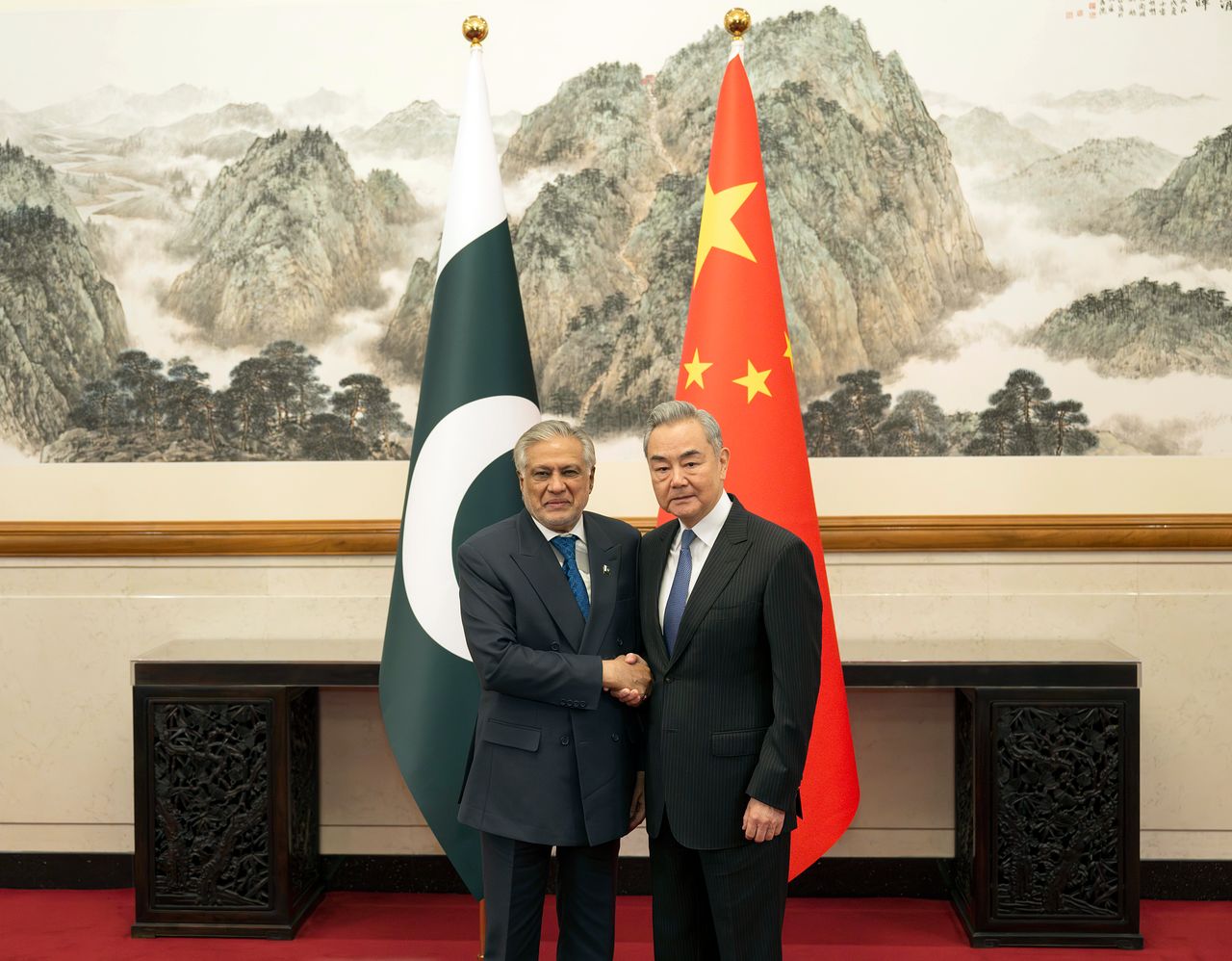 3月31日、北京・釣魚台国賓館で中国の王毅外交部長（右）がパキスタンのイスハーク・ダール副首相兼外相と握手している。同日、両国の外相は中東和平のための5大イニシアチブを発表し、即時終戦を促した。新華社＝聯合ニュース