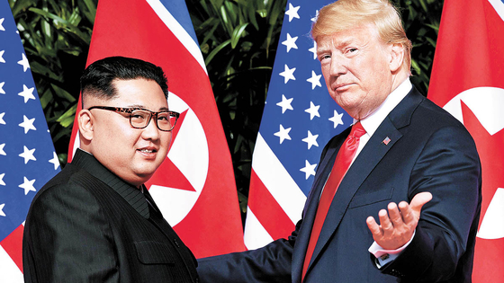 2018年6月、シンガポールで行われた首脳会談を前に、トランプ米大統領（右）が金正恩（キム・ジョンウン）北朝鮮国務委員長とあいさつを交わしている。［AFP＝聯合ニュース］
