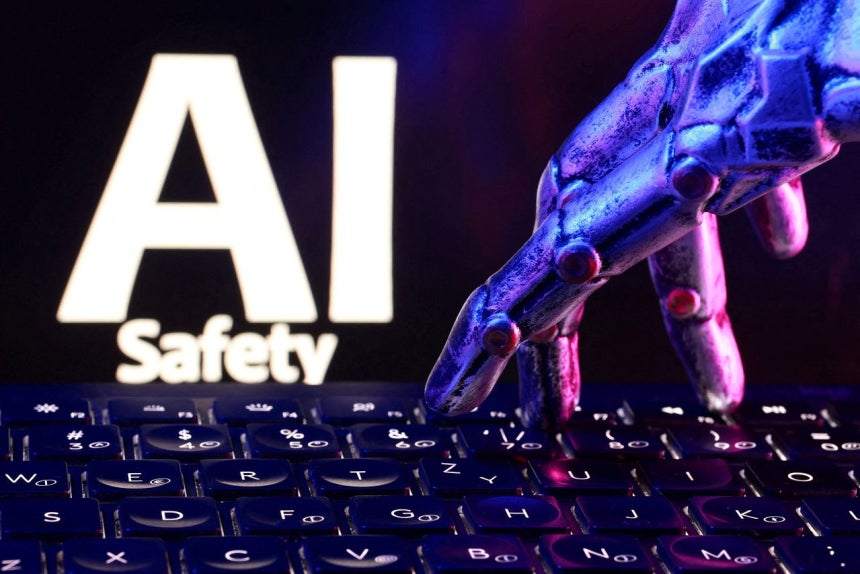 「AI安全（AI Safety）」という文字とキーボード、ロボットの手。ロイター＝聯合ニュース